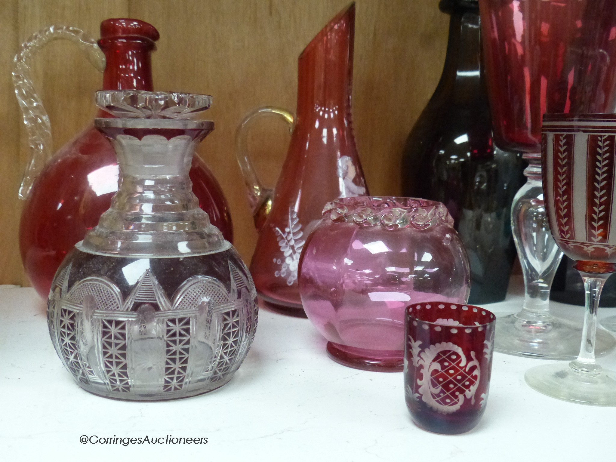 A pair of amethyst glass decanters, cranberry glass and mixed 19th and 20th century coloured glassware